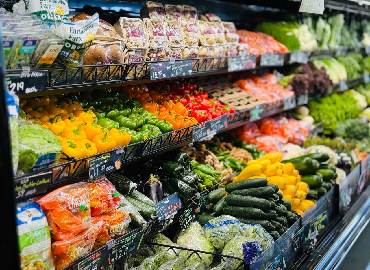 services-01 Vibrant variety of fresh vegetables and fruits on grocery store shelves, showcasing healthy choices.