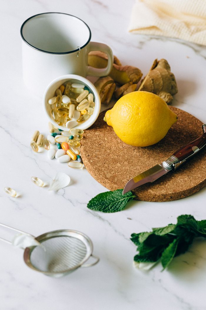 services-02 A flat lay of natural ingredients and supplements featuring lemon, ginger, and pills.