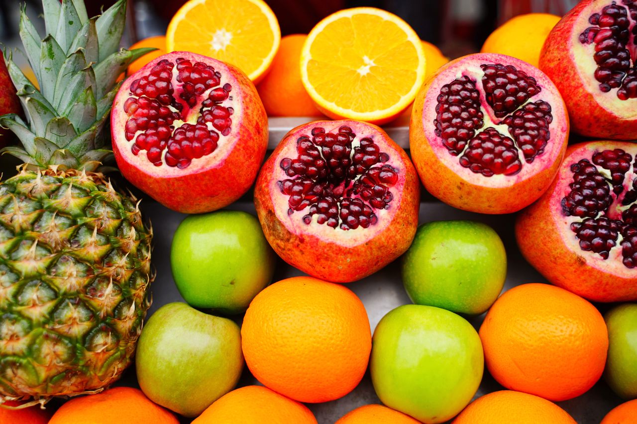 The Art of Drawing Readers In: Your attractive post title goes here A colorful assortment of fresh fruits including pomegranates, oranges, and apples, ideal for healthy eating themes.